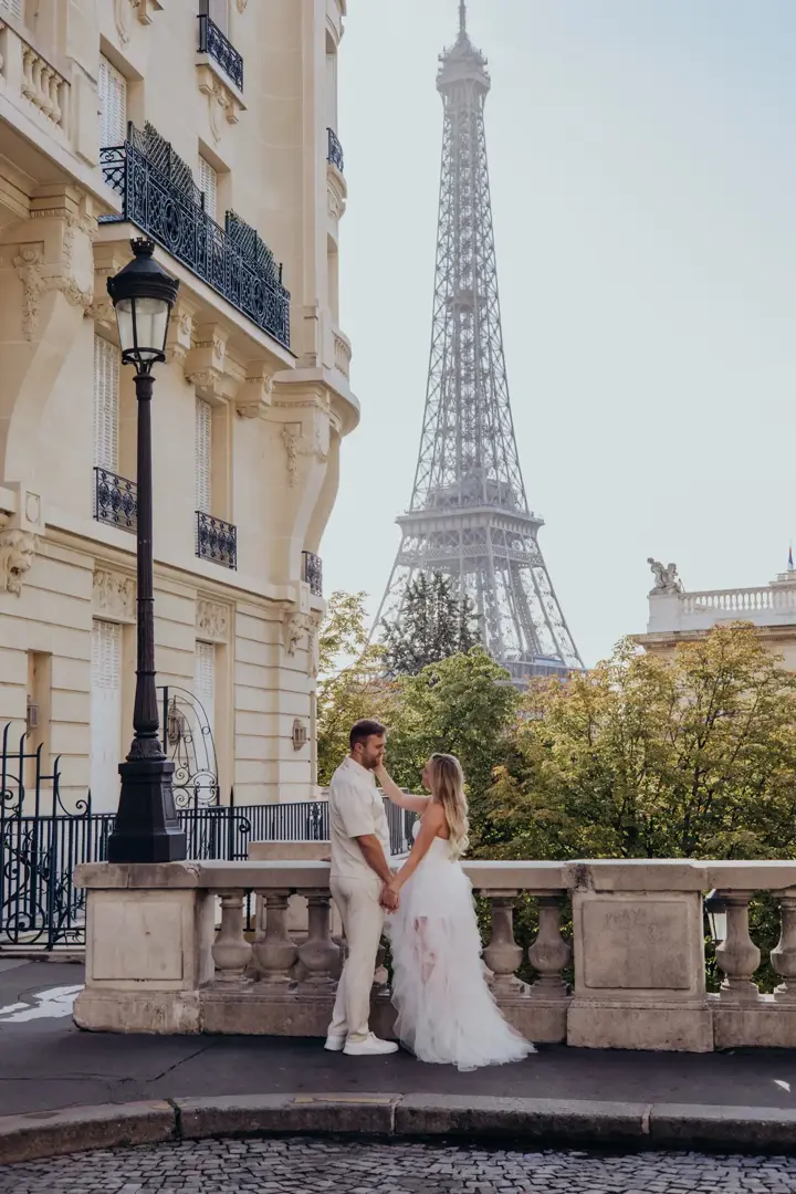 Couple balcony Eiffel Tower view pink dress Paris