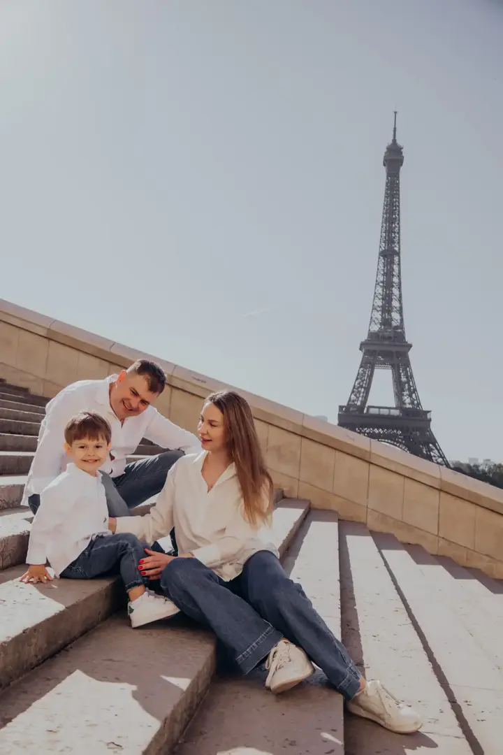 Family sitting on Trocadero steps Eiffel Tower Paris