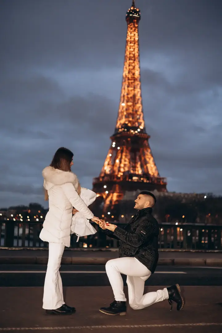Night proposal on knee Eiffel Tower lights Paris